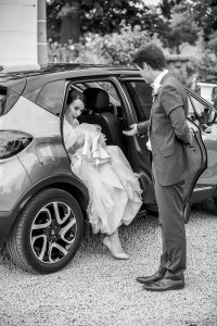 L'épouse sortant de la voiture aidé de son mari.